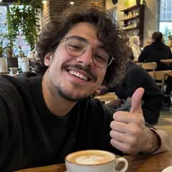 Adrian taking a selfie in a cafe