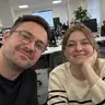 Coworkers taking a group selfie in an office