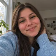 Sonia taking a selfie at home by a window